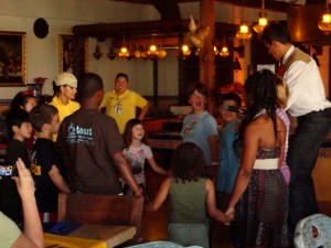 All the kids will pass a hat around, hoping not to be caught with it