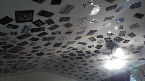hundreds of postcards stapled to a vaulted ceiling